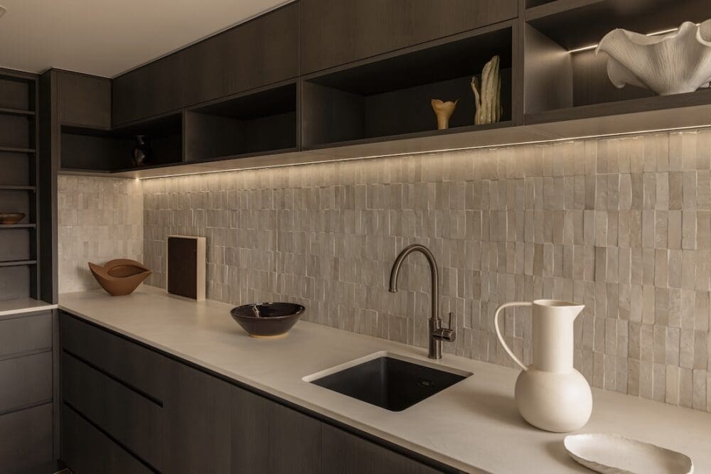 Walk in pantry with timber cabinetry and tiled backsplash in Deakin Home